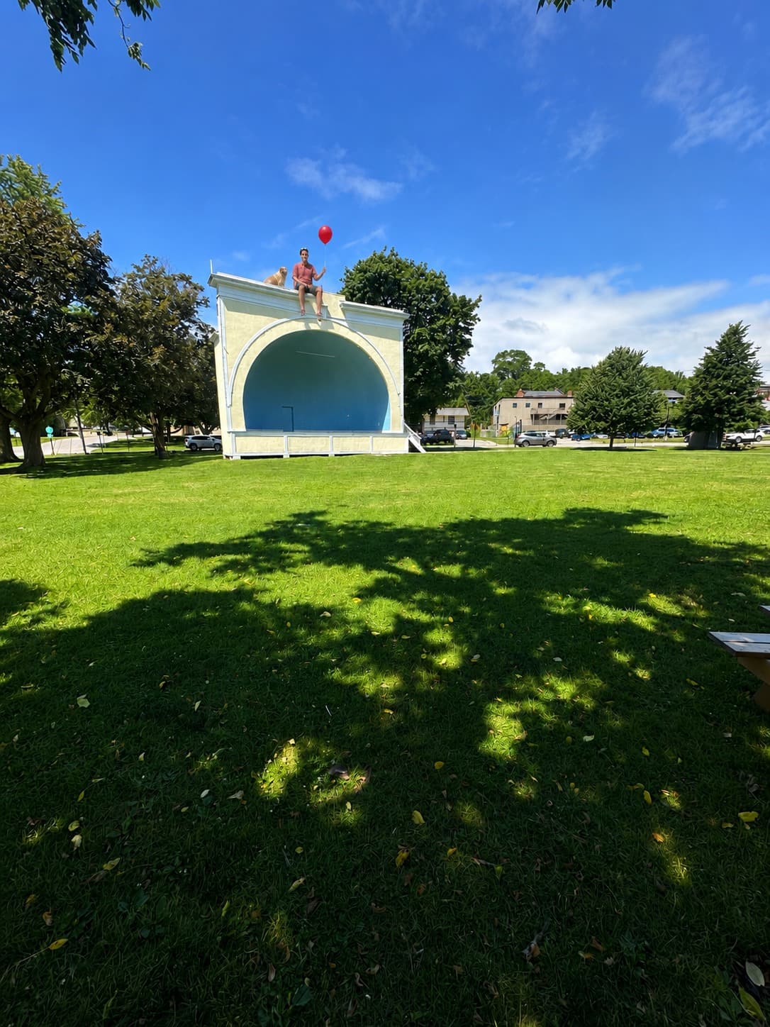 Memorial Park bandshell in Port Hope with Jordan and Buddy subtly sitting on top holding a red balloon.
